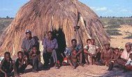 Bushmen in front of hut