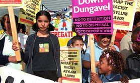 Children protest with signs and placards. Signs read No Detention, No Deportation