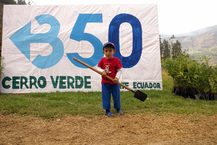 Boy next to cerro verde banner
