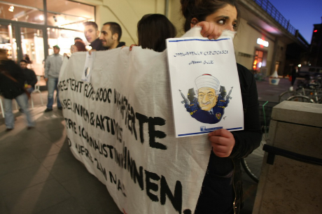 25 left-wing and kurdish activists demonstrate with banner and caricature of Gülen against a event about the Gülen Movement