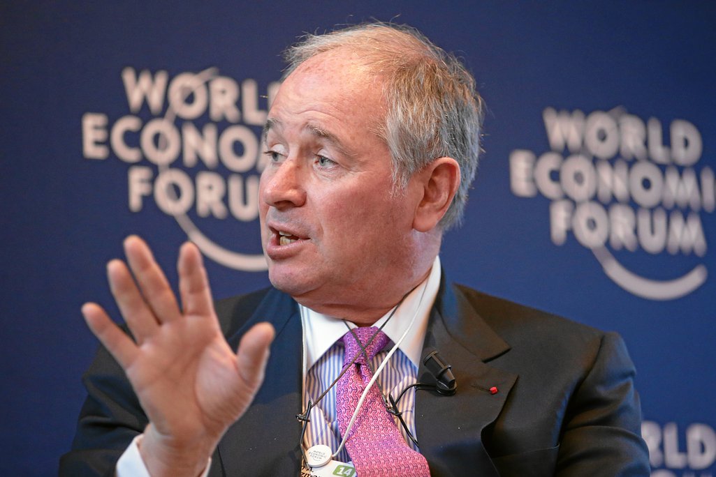 Man speaking in front of a World Economic Forum backdrop