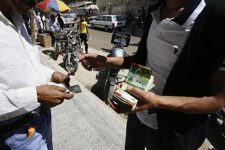 Fatah members withdrawing foreign aid currency in Rafah