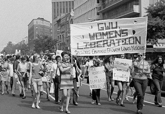 Women marching holding a banner in Washington DC, 1970