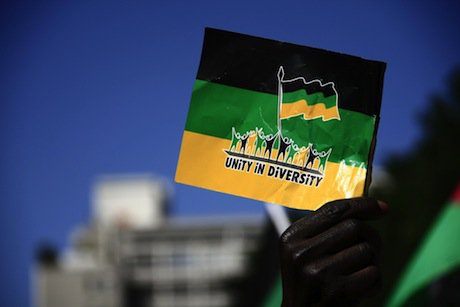 An ANC supporter holds the party&#39;s flag during a march in Cap Town. Demotix/Miriam Mannak. All rights reserved.
