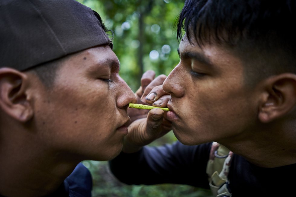 Bebeto, one of G.I.A.'s youngest, blows rapé on Christian's nose, one of his companions, during a routine tour. Rapé is a dust drawn from a mixture of tobacco and other medicinal plants, considered traditional medicine.