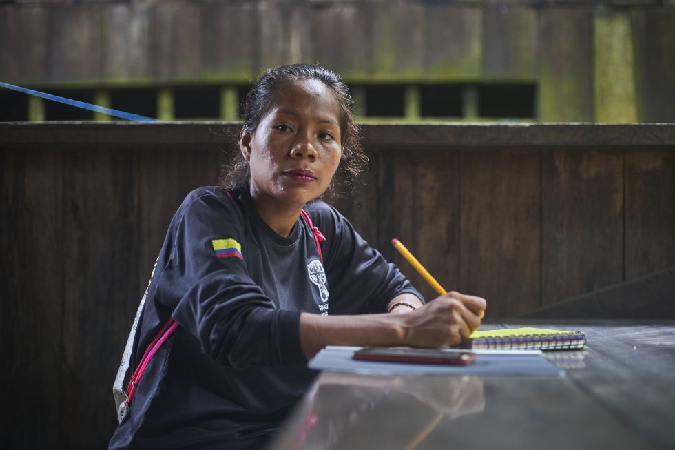 Gloria, one of the women who belongs to the Guardia Indígena Ambiental de San Martín de Amacayacu, takes notes during the conversation foreseeing a routine inspection in the Ticuna territory.