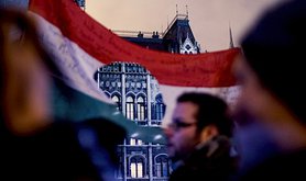 Anti-government demonstrators wave a cut-out Hungarian flag, the symbol of the 1956 Revolution, in front of the Hungarian parliament. Demotix/Peter Nemeth. All rights reserved.