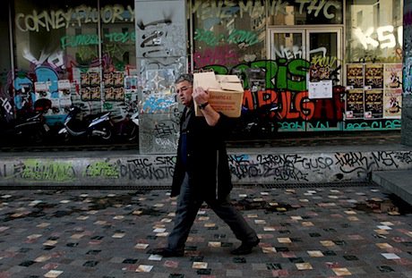 A worker outside a closed shop in Athens. Demotix/Panayiotis Tzamaros. All rights reserved.