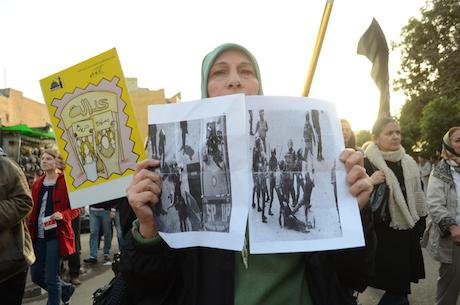 A protester holds pictures of a victim that was stripped by army forces in 2011. Demotix/Halim Elshaarani. Alll rights reserved.
