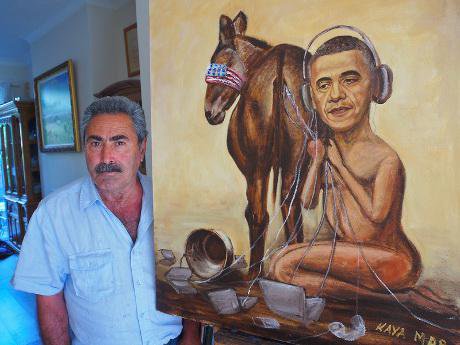 Political painter Kaya Mar with his new painting of US President Barack Obama eavesdropping on a blindfolded nation.
