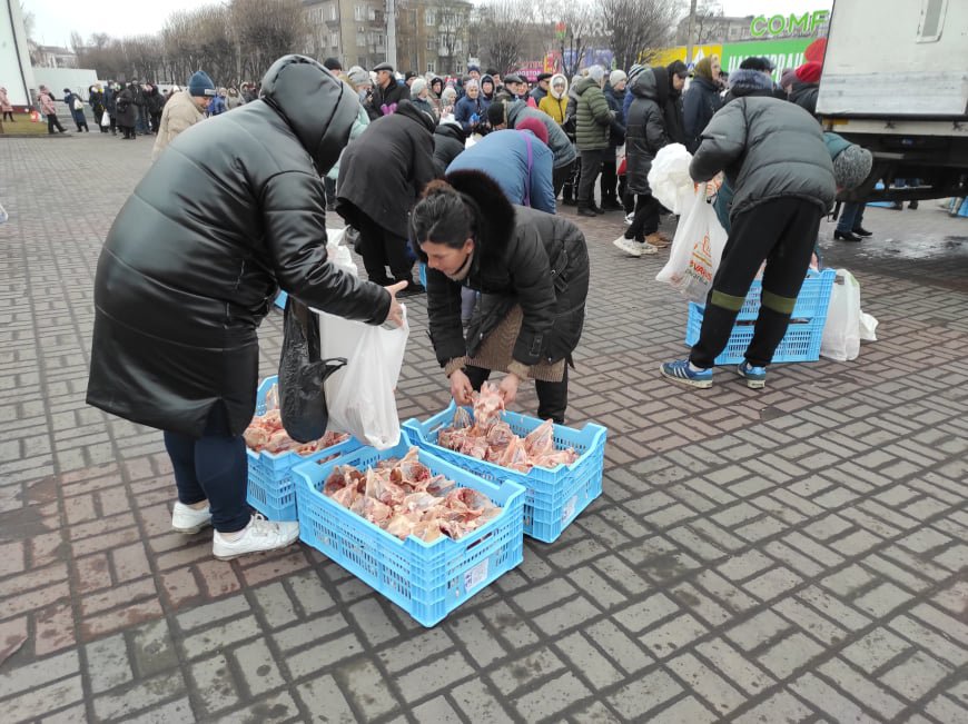 People are seen collecting chicken soup kits -- chicken carcasses from which the meat has been removed -- in Ukraine