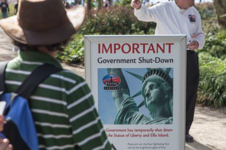 A sign warns of the temporary closure of the statue of liberty in New York City due to the government shutdown.