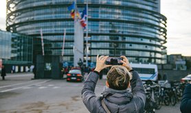 A woman taking a photo of the European Parliament building in Strasbourg, France | ifeelstock / Alamy Stock Photo. All rights reserved