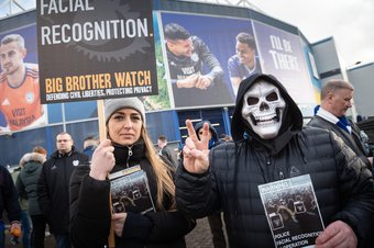 Football fans cover their faces with masks in protest at the police's decision to utilise facial ID technology as they arrive at Cardiff City Stadium to watch the South Wales derby between Cardiff and Swansea. 12 January 2020.