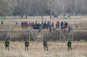 Greek police and soldiers in front of a fence at Kastanies, Evros, trying to deter migrants as they attempt to enter Greece from Turkey - March 2, 2020