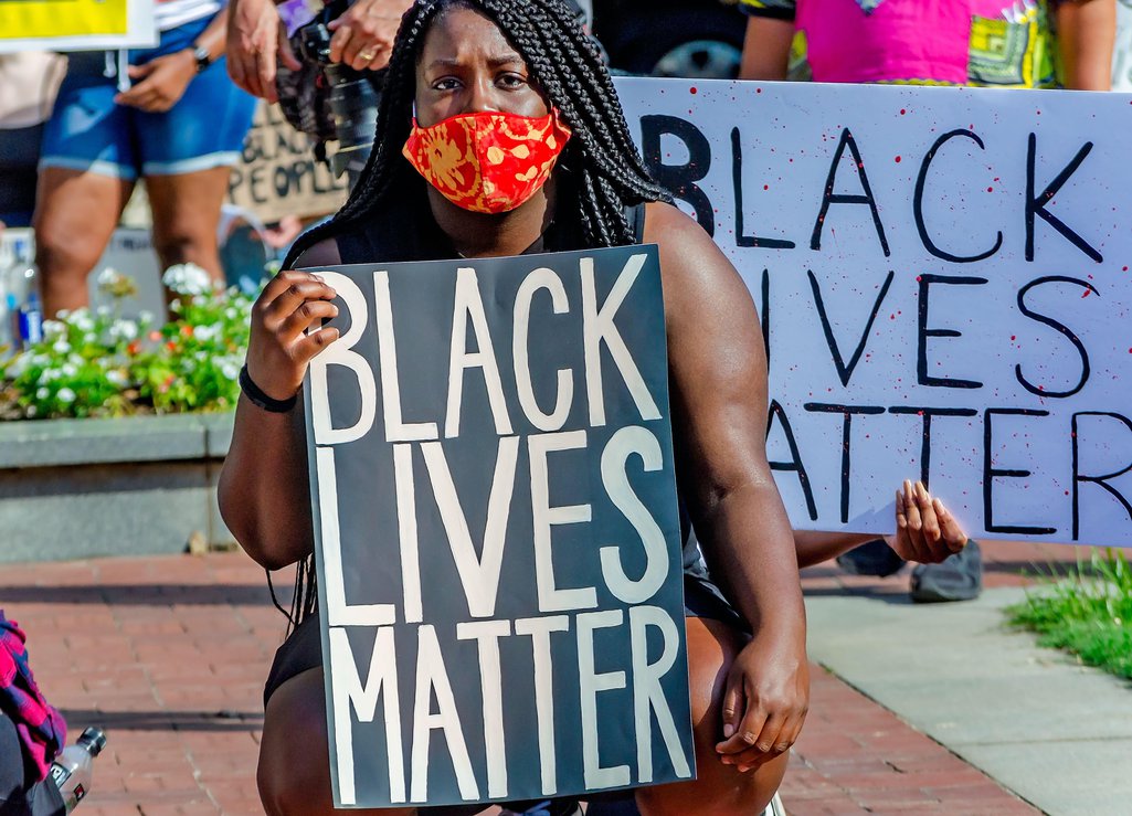 A woman holds a placard at a Black Lives Matter protest in Alabama, 2020.