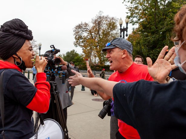 A Trump supporter verbally attacks a Black woman protesting the confirmation of Amy Coney Barrett and in favor of reproductive, civil, and women's rights. Washington, DC, USA, 26 October, 2020