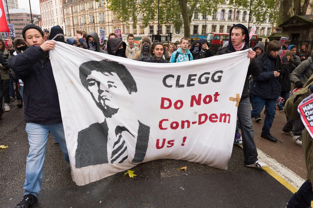 Protesters hold a banner reading 'Clegg: Do not Con-demn us'