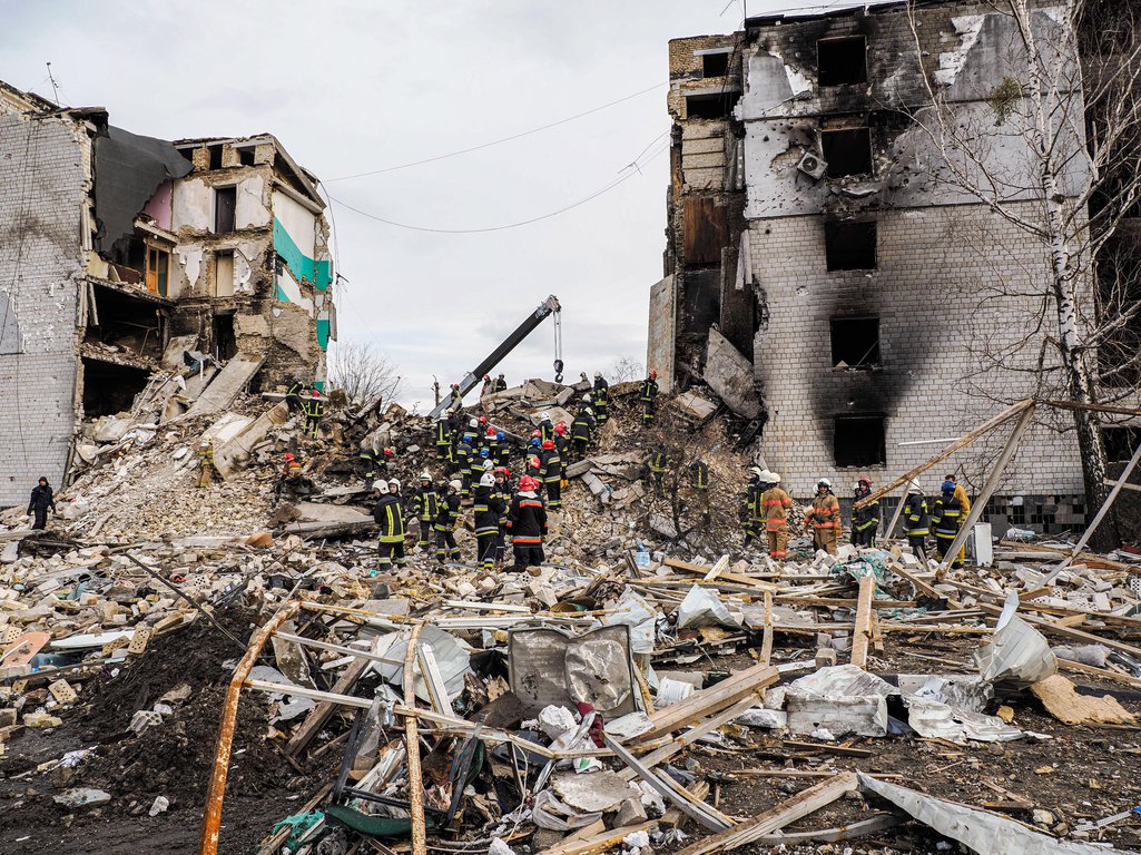 Fire fighters seen cleaning debris of a collapsed building in search of the dead bodies of those killed by collapsed buildings, 6 April 2022
