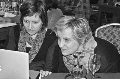 Two women look at a computer together