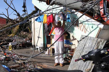 Man hangs washing in Tacloban City, Philippines. Demotix/Herman Lumanog. All rights reserved.