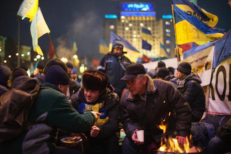 Protesters discuss current affairs near the fire at the Independence Square, Kiev.