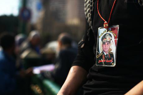 A young man wears a General Sisi picture in Tahrir Square