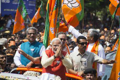 Surrounded by a crowd of supporters, Narendra Modi filed his nomination papers