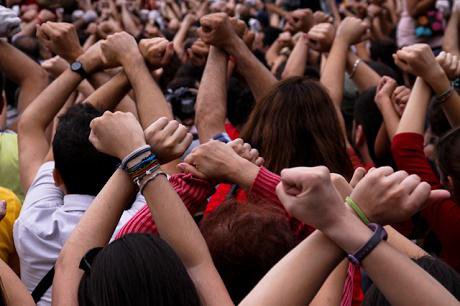 A group of people raising their hands in Barcelona.