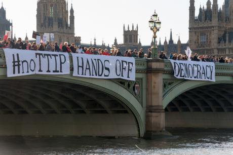 Banner drop protest at EU-US trade deal off Westminster Bridge, Oct.2014.