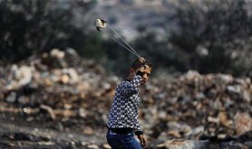 Palestinian boy with a slingshot. Ahmed Talat/Demotix. All rights reserved.