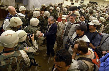Secretary of Defense Donald H. Rumsfeld in 2004 poses for pictures with soldiers, marines and airman outside the Abu Ghraib Dete