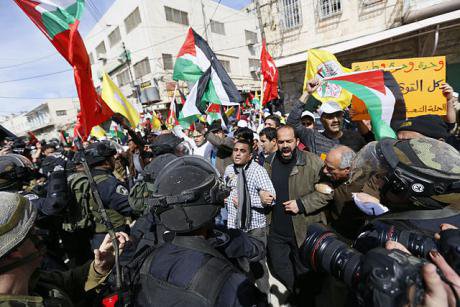 Isaeli army and border police troops stop Palestinians entering Al-Shuhada ( Martyrs') St., Hebron, during the demo on the twent