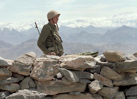 A Soviet soldier stands guard on an Afghan road. 15 May 1988.