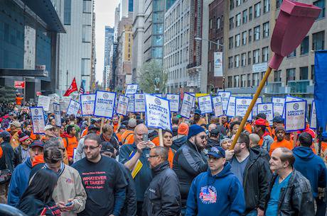 Stand up against income inequality protesters march on May Day