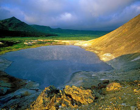 The Kurilsky nature reserve. A blue cwm lies among ragged yellow rocks