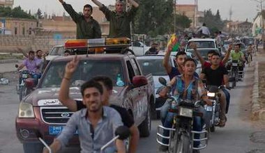 Kurd fighters and residents celebrate capture of Mabrouka from ISIS. Björn Kietzmann/Demotix. All rights reserved.