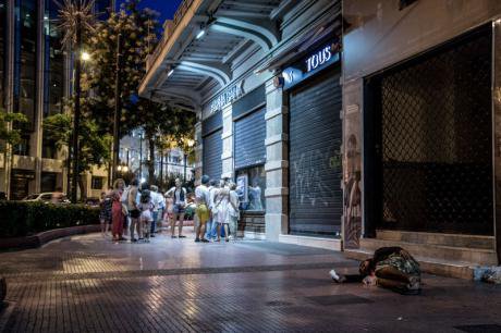  ATM queue near pro-EU rally with homeless man.