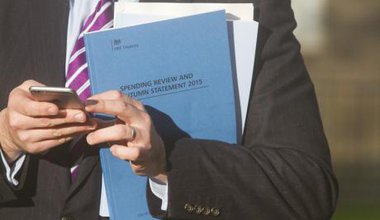 An MP holds the 2015 Autumn statement spending review booklet.