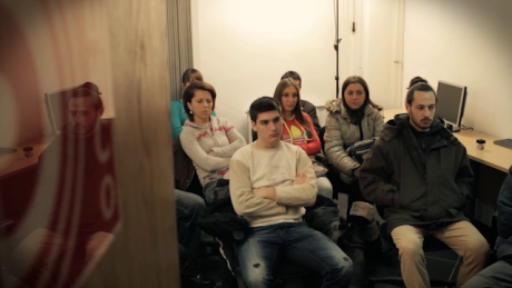 A group of Bosnia youth sit in an office during a labour presentation