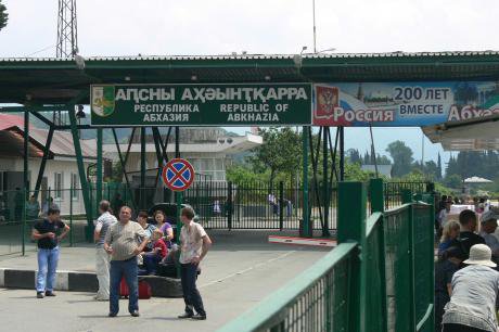 Border crossing in Abkhazia. The sign on the right reads 'Abkhazia and Russia, 200 years together.'
