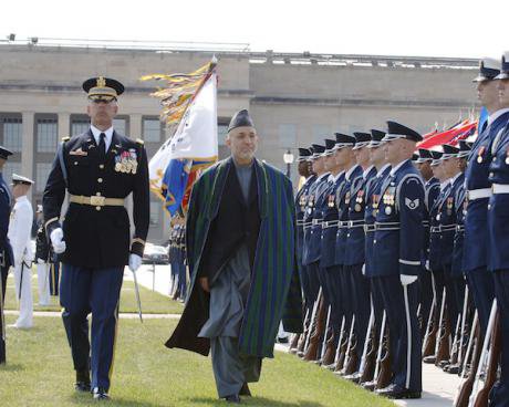 Afghan President Hamid Karzai walks past a regiment of US troops in dress uniform outside the Pentagon.