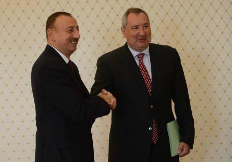Dmitry Rogozin shakes hands with Azerbaijan&#39;s president Ilham Aliyev in September 2014.