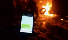 A Ukrainian protester receives an anonymous text noting they are 'registered in mass disorder'