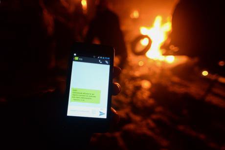 A Ukrainian protester receives an anonymous text noting they are &#39;registered in mass disorder&#39;