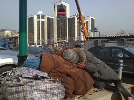 Two beggars sleep in front of Lukoil's headquarters, 2010.