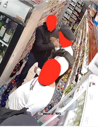 Man in dark hoody shakes hand of police officer