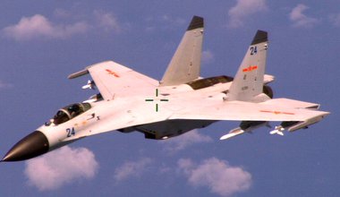 An armed Chinese Shenyang J-11 fighter jet flies near a U.S. Navy Boeing P-8A Poseidon patrol aircraft over the South China Sea about 220 km east of Hainan Island in international airspace. 19 August 2014