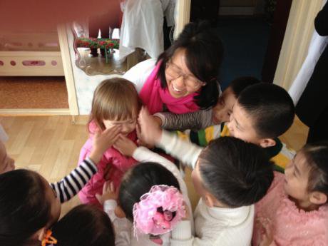 Woman and child surrounded by children