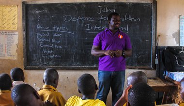 Defence for Children International-Sierra Leone staff member speaks to classroom of children in Adonkia community in Western Area- They do school out reach to talk about child rights, child participation in school governance, sexual gender based violence